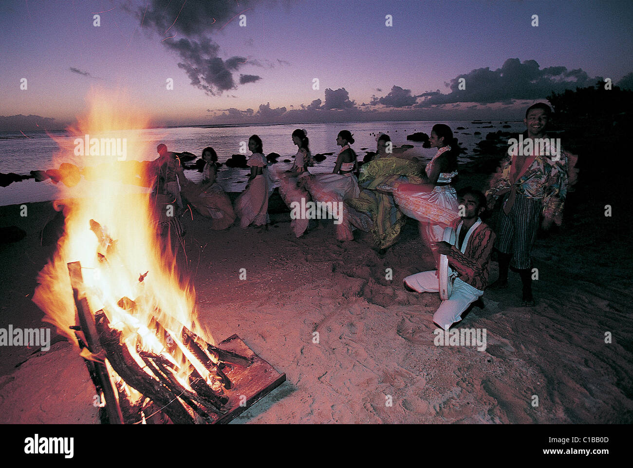 Mauritius), Women dancing the traditional Sega in the evening on a beach,artistic blur of the movement Stock Photo