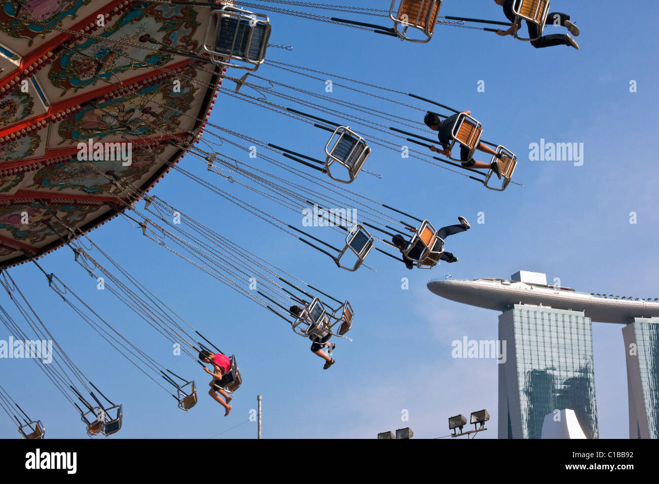Amusement ride with Marina Bay Sands in the background.  Marina Bay, Singapore. Stock Photo