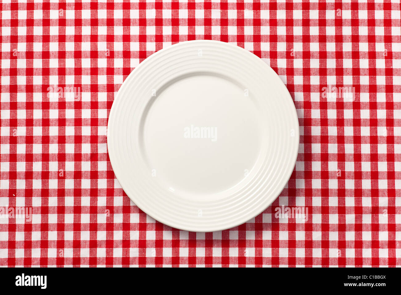 the white plate on checkered tablecloth Stock Photo