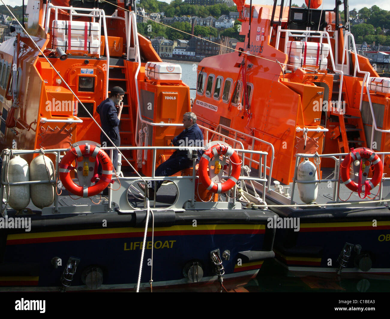Two working lifeboats undergoing maintenance, Oban Harbour Stock Photo