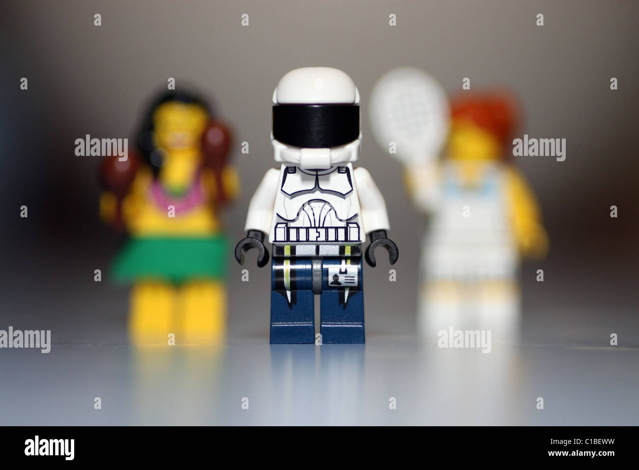 Lego man with two lego ladies behind him Stock Photo