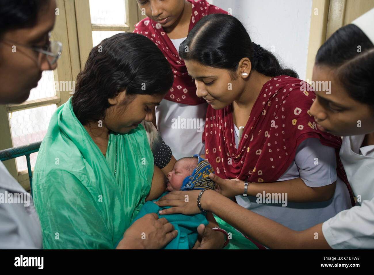 Midwives at Kolkata Nursing College help new mother to breastfeed, India Stock Photo