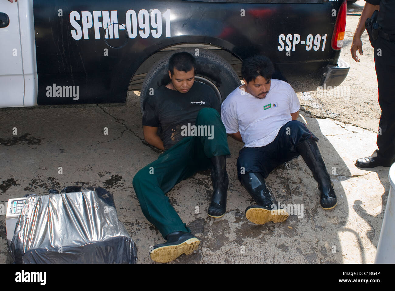Veracruz police arrest two men for looting houses that had been abandoned because of Hurricane Karl. Stock Photo