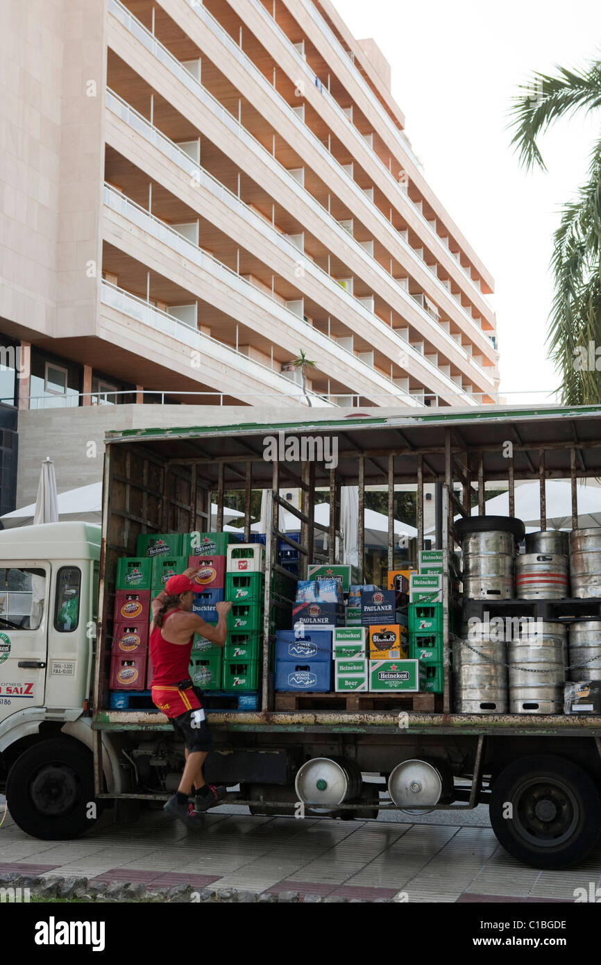 Man worker delivering beer cases and barrels on truck in Mallorca Majorca Spain Stock Photo
