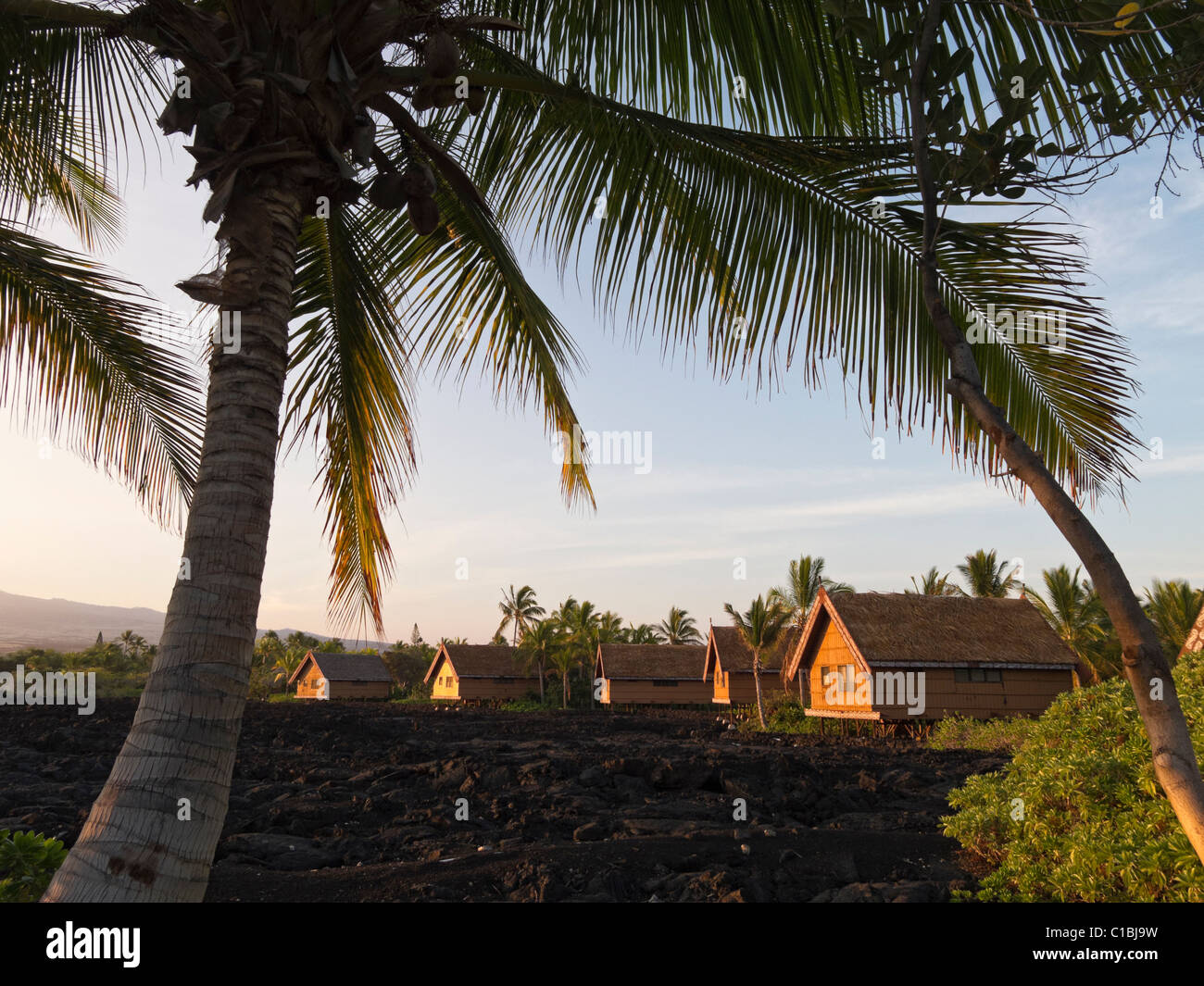 Thatched roof huts house guests at famous Kona Village in Kailua-Kona, Hawaii. Stock Photo