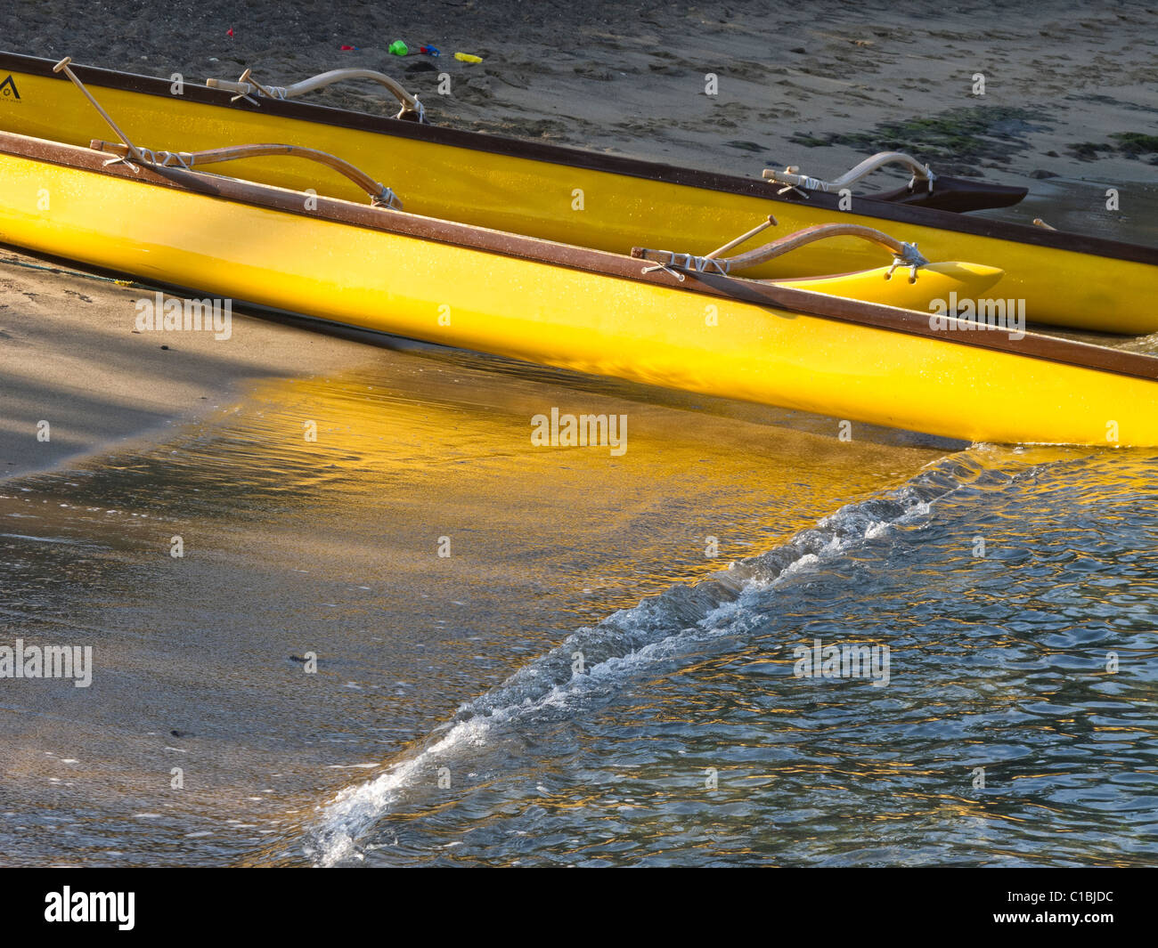 An outrigger canoe on the ocean shore at Kahuwai Bay in Kona, Hawaii
