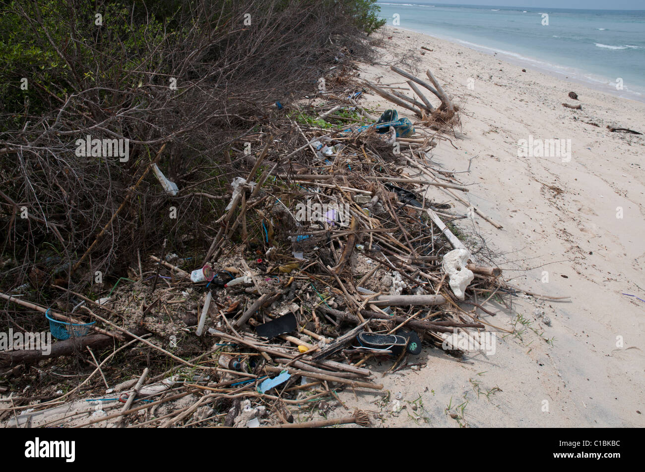 Rubbish and other detritus on a white sand beach on Gili Trawangan an island off Lombok Stock Photo