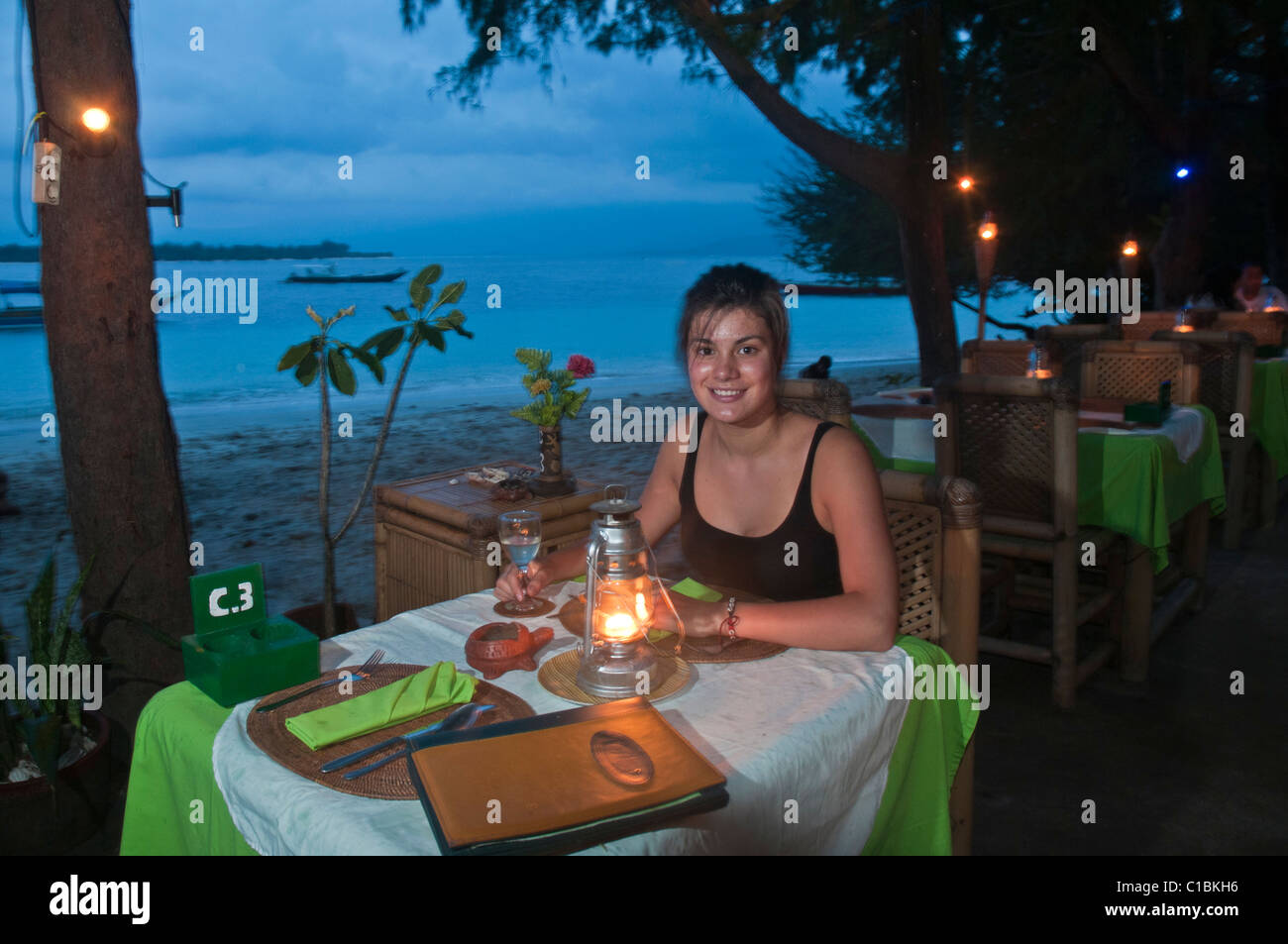 Pretty teenage girl at beachside restaurant on Gili Trawangan a small island in the Gili group off Lombok Indonesia Stock Photo