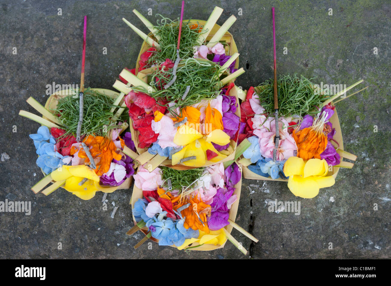 Morning offerings on the footpath in Ubud Bali Indonesia Stock Photo