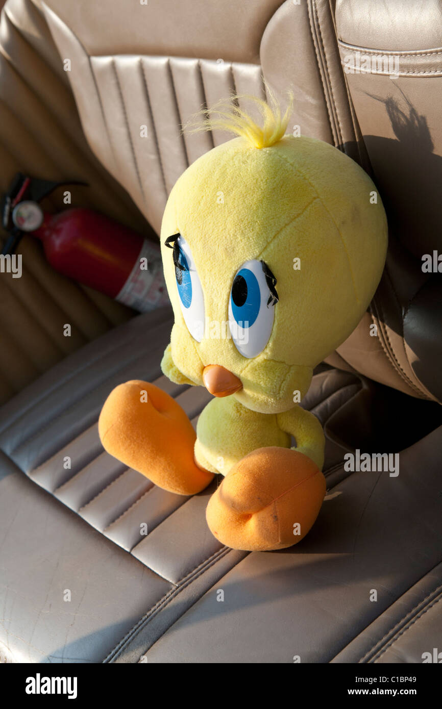 Tweety bird stuffed animal on car seat. Stock Photo