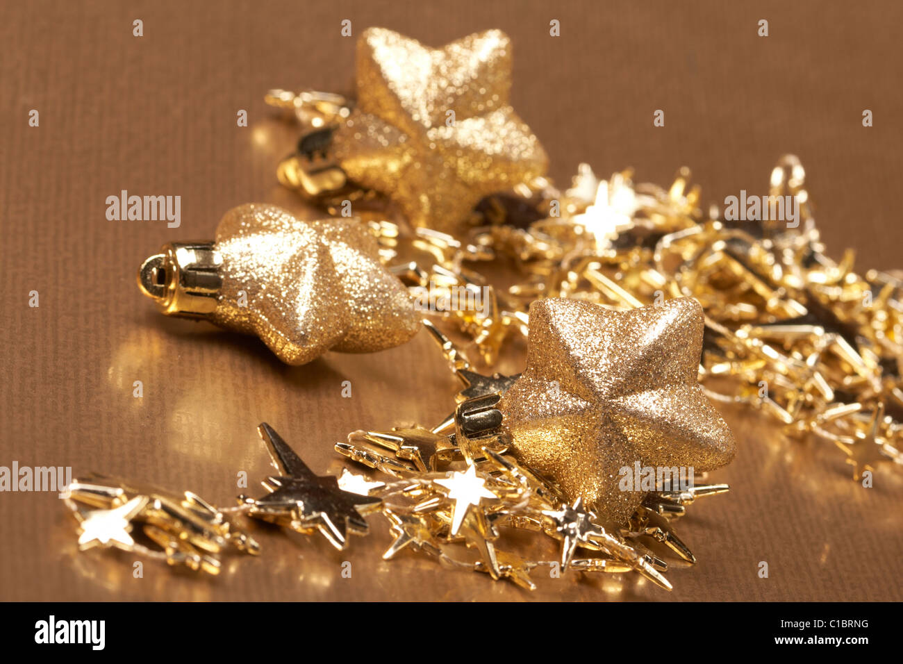 Christmas gold stars on the gold background Stock Photo - Alamy