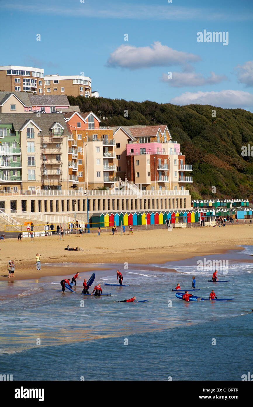 Surfers on the beach at with the controversial artificial surf