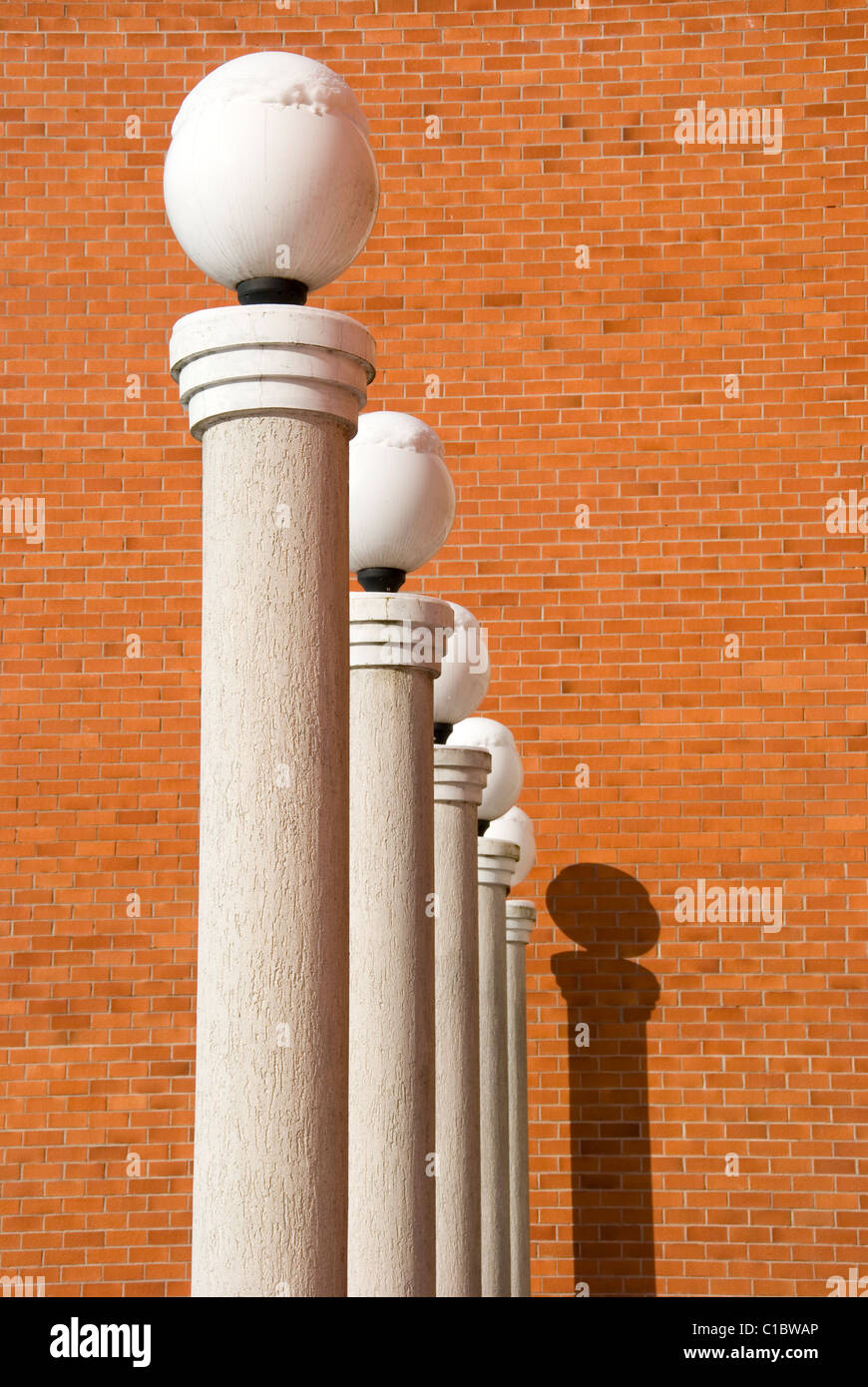 lamps on five white columns and red wall Stock Photo Alamy