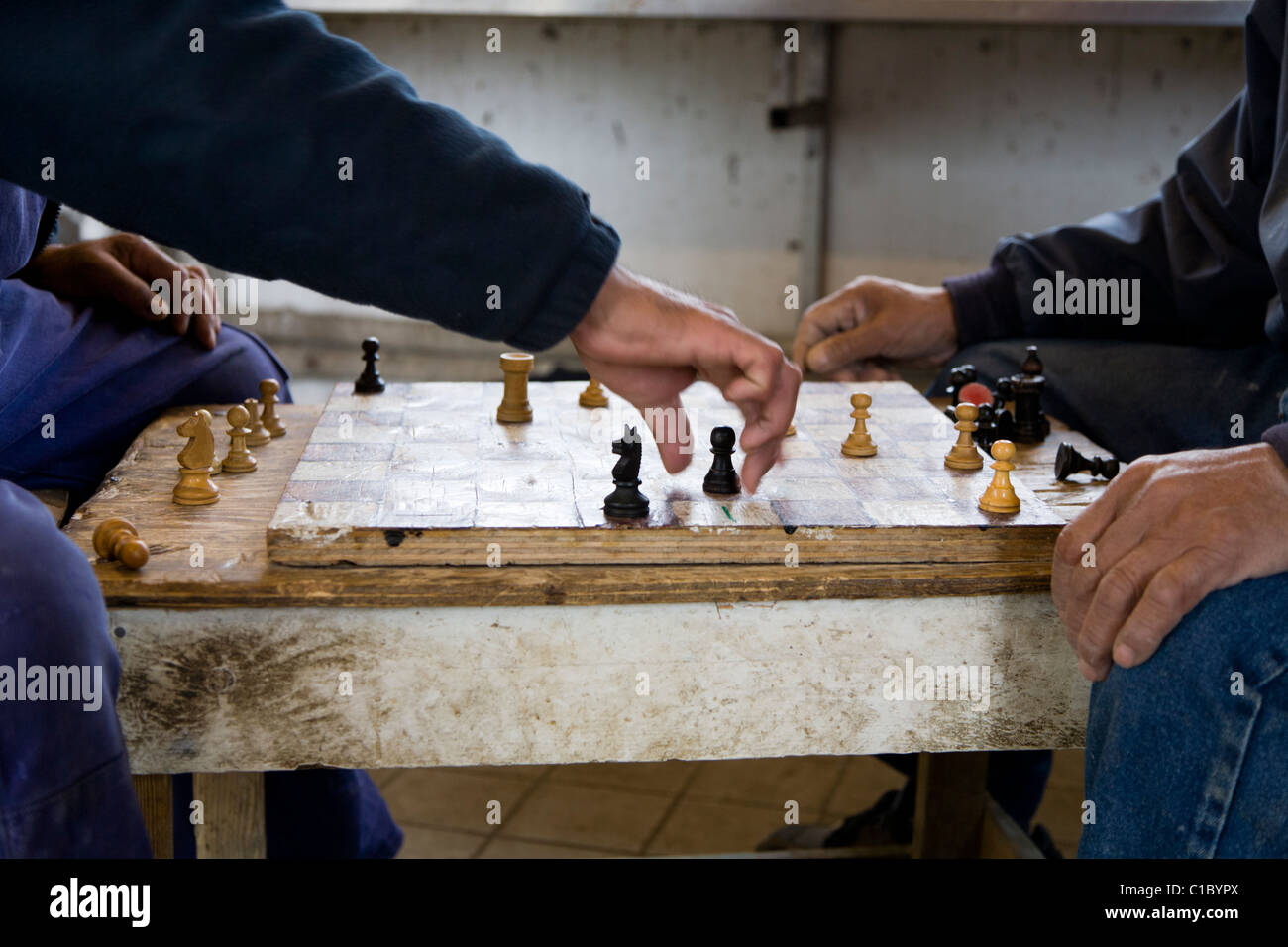 Fishermen playing 'Checkers' board game. Also called 'Draughts' board game. Fishermen´s huts, Narsaq, South Greenland Stock Photo