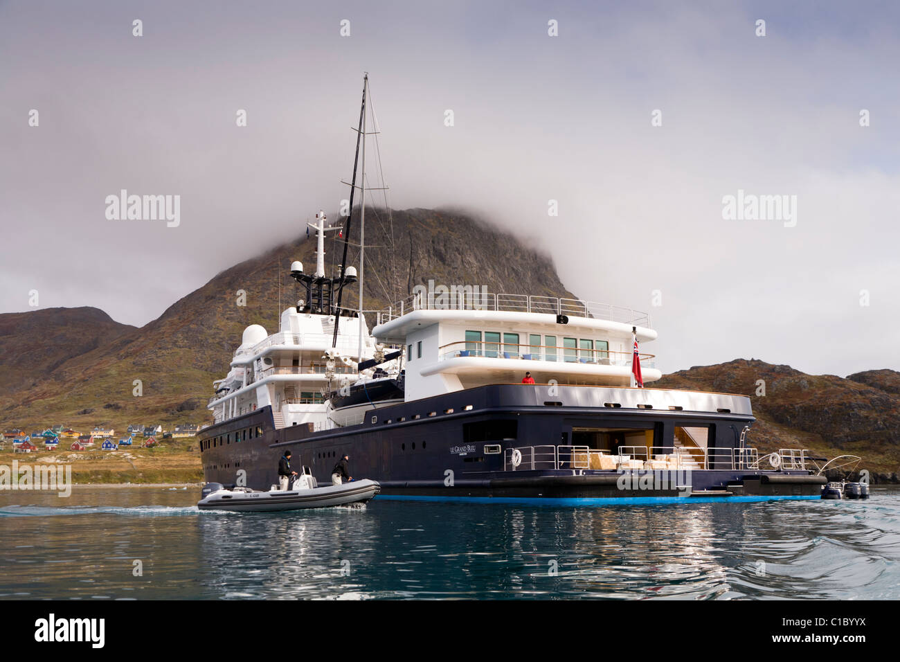 Luxury private yacht Le Grand Bleu guarded by security guards on a Zodiac. In the fjord outside Narsaq, South Greenland Stock Photo