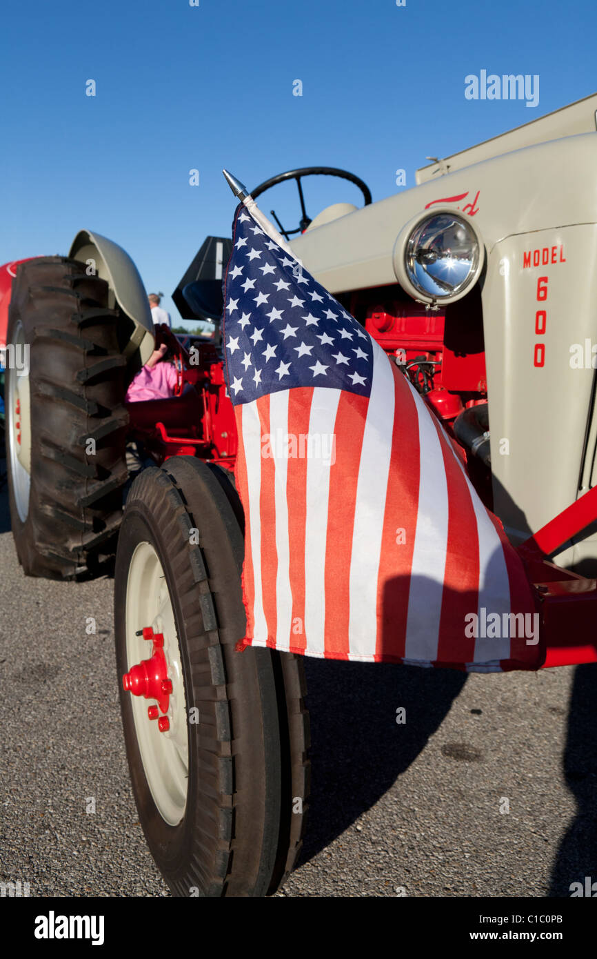Old Ford tractor with American flag. Stock Photo