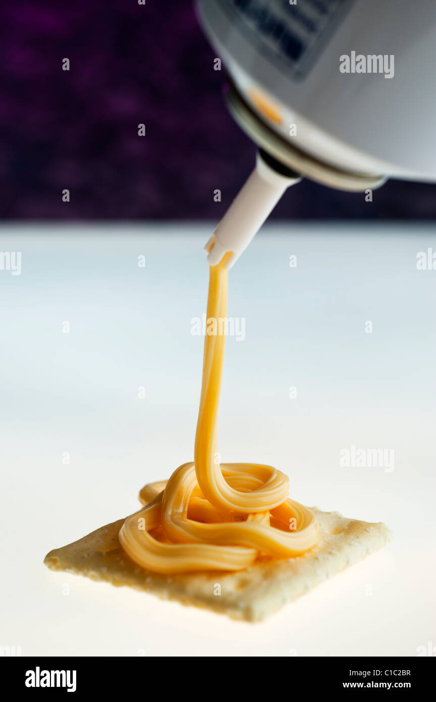 Canned spray cheese and a saltine cracker Stock Photo Alamy