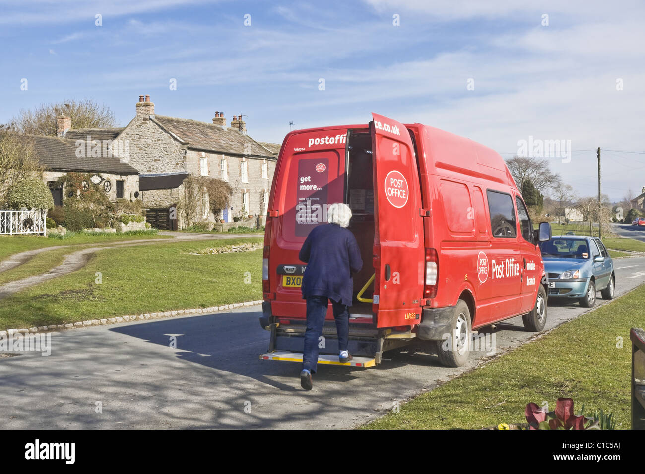 The mobile Post Office on one of its twice weekly visits to Bellerby in North Yorkshire.  The van stays for one hour per visit. Stock Photo