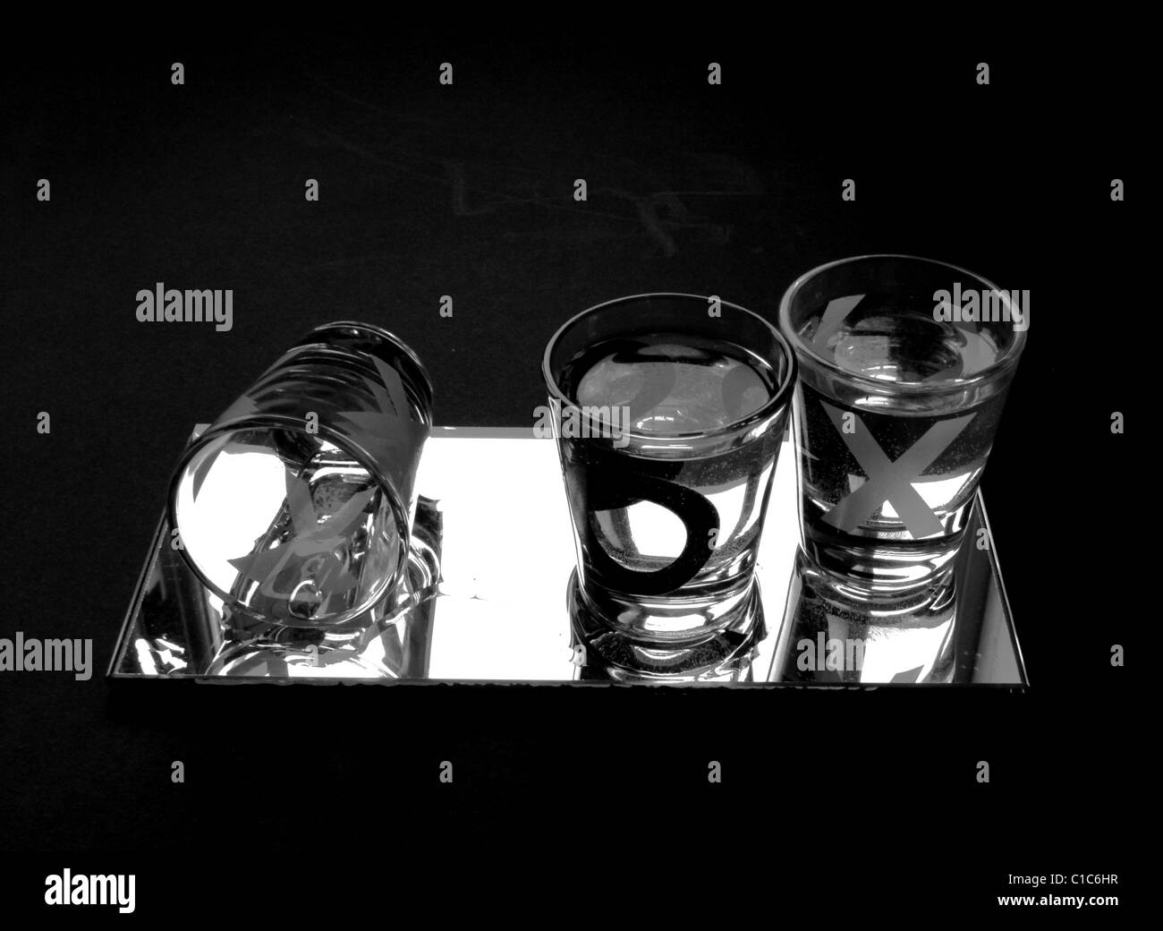 Noughts and Crosses Shot Glasses on Mirror with Black Background shot