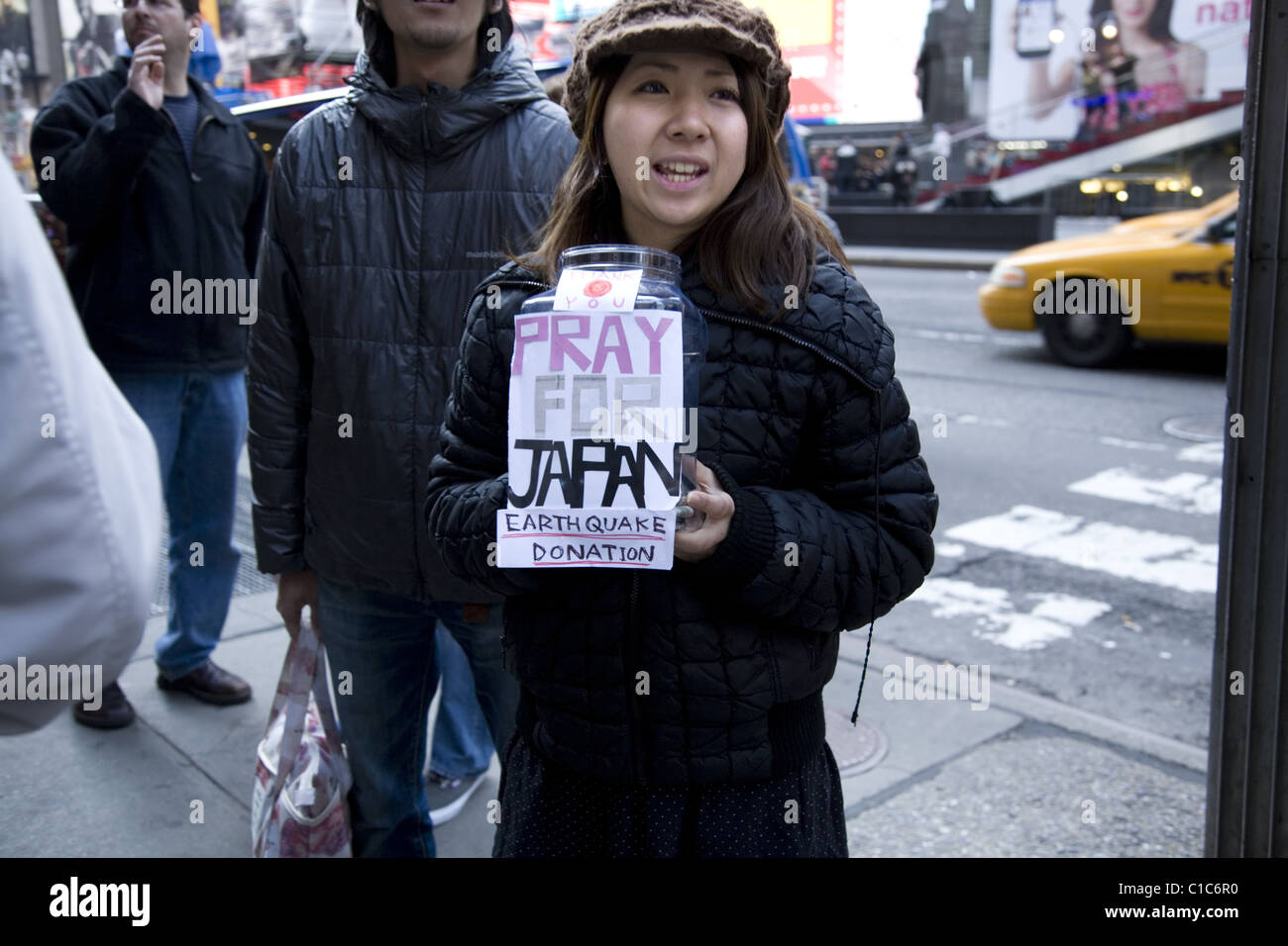 March 12, 2011: Japanese woman asks for donations for Japanese earthquake victims in Times Square, New York City. Stock Photo