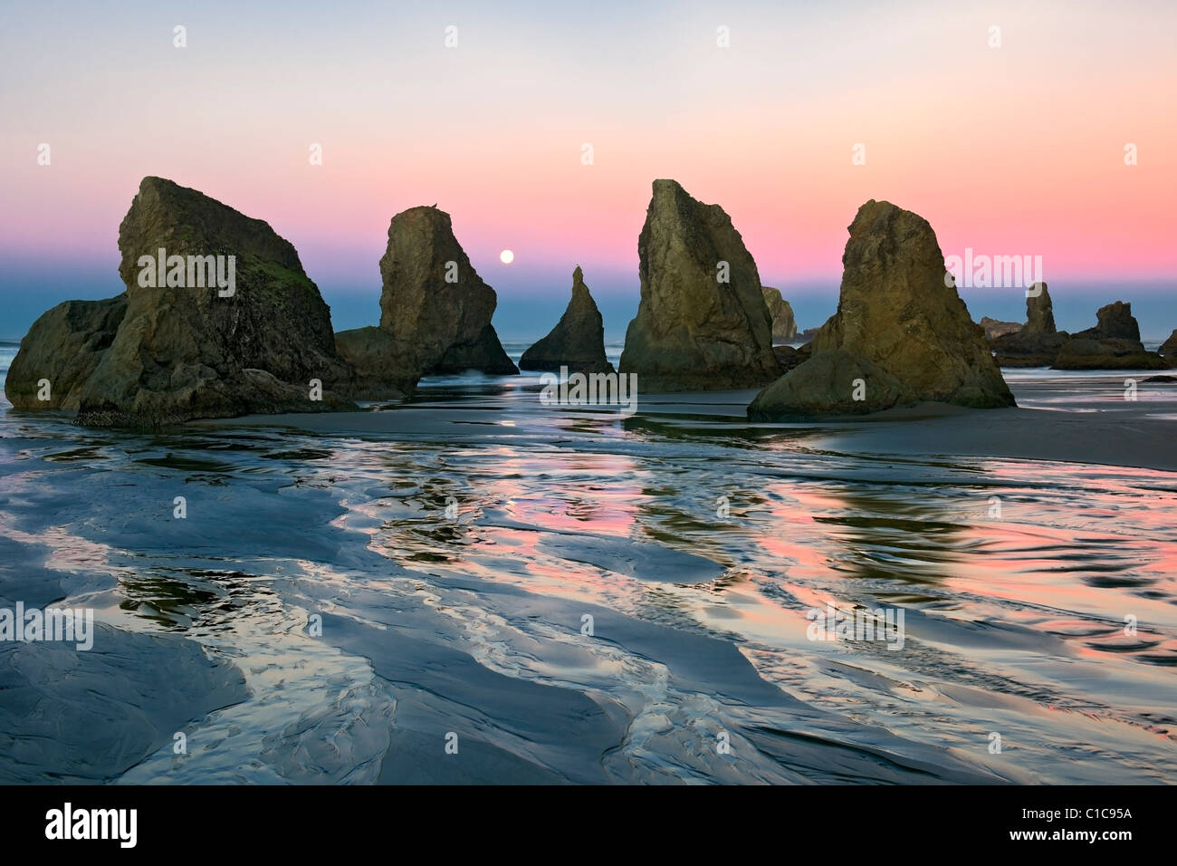 Moon sets as sunrise color bathes the many sea stacks at Oregon #39 s Moon sets as sunrise color bathes the many sea stacks at Oregon #39 s