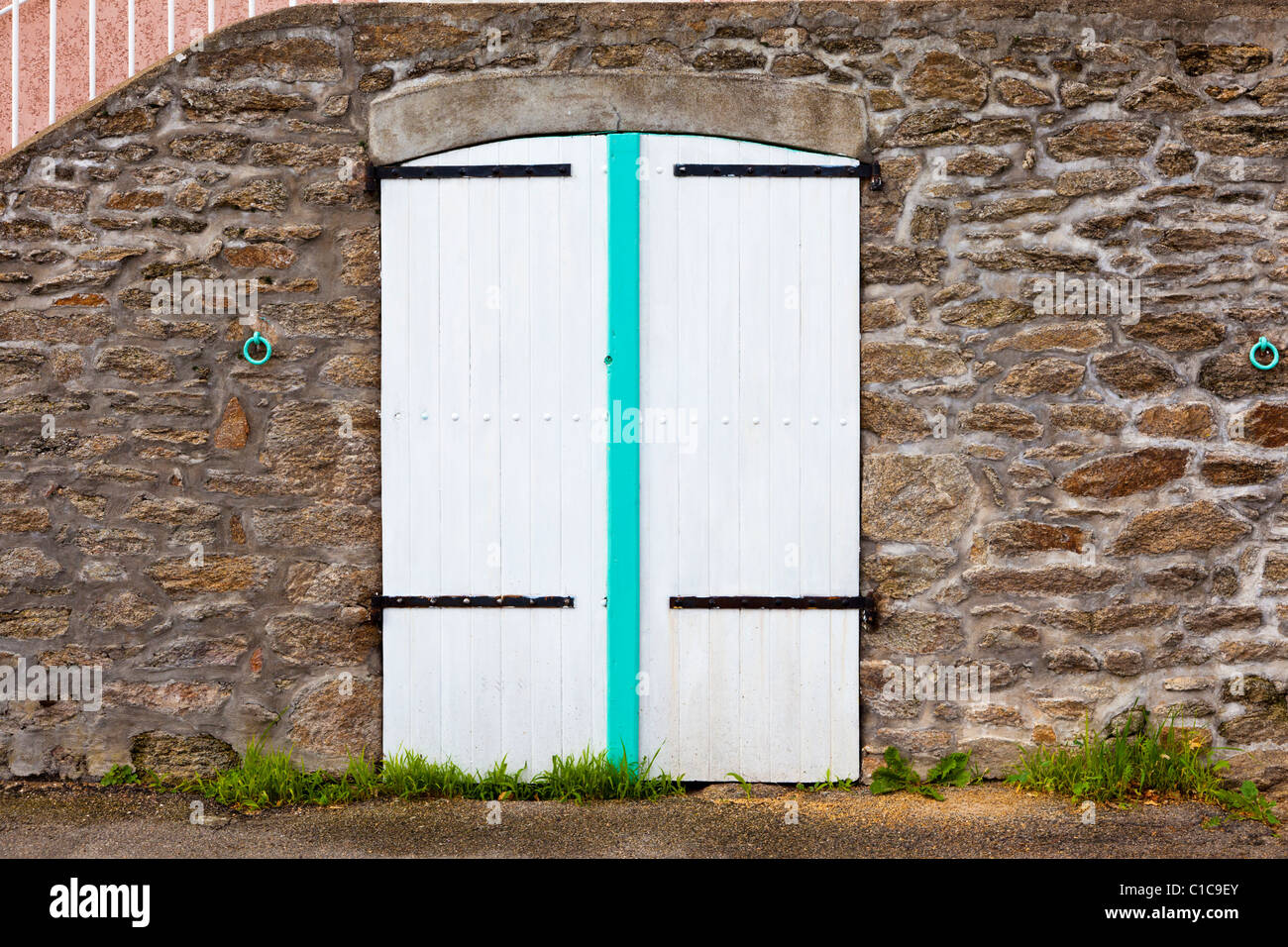 White wooden garage doors in wall, France, Europe Stock Photo