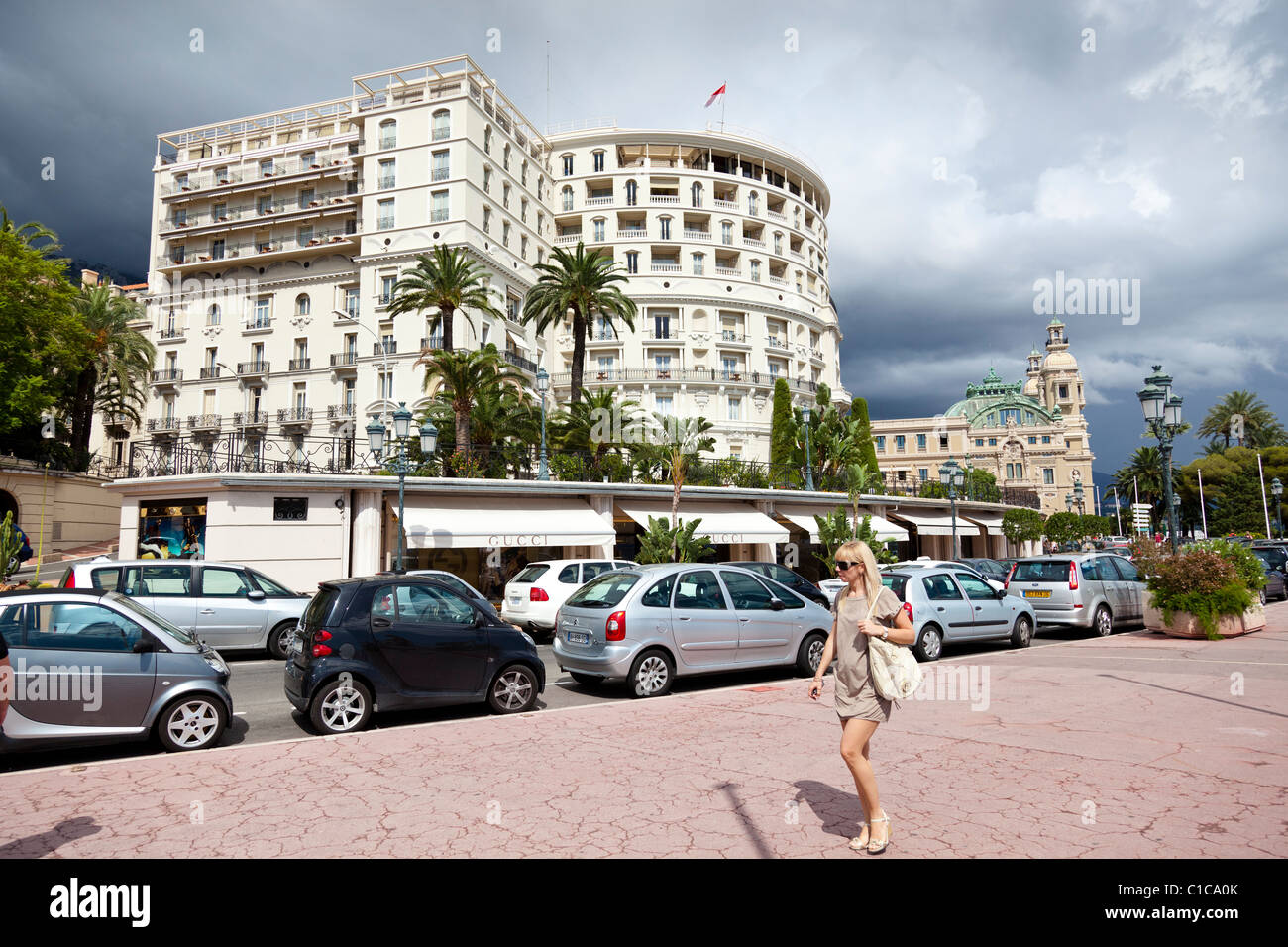 Woman walks along the pavement above the harbour in Monte-Carlo. Stock Photo