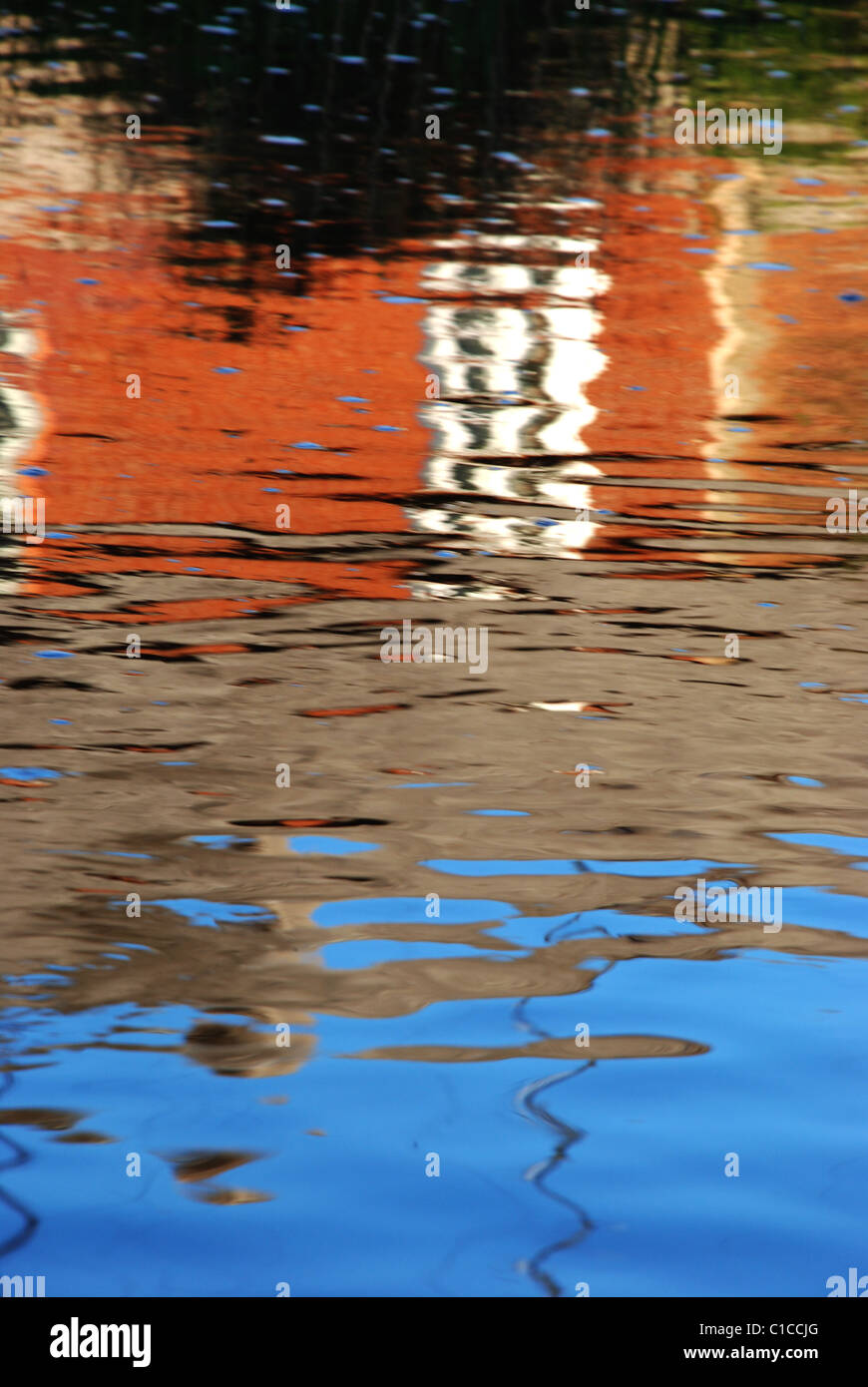 Colorful reflections in the water reminds painting stired by the wind. Stock Photo