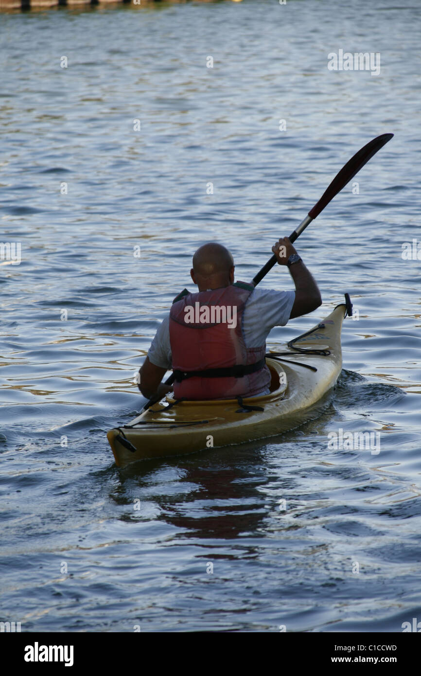 man with lifejacket rowing a canoe on lake Stock Photo - Alamy