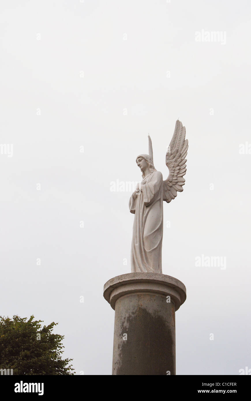 White angel with elevated wings on column Stock Photo