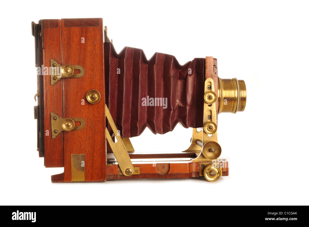Very Old Camera on a wooden tripod on a white background Stock Photo