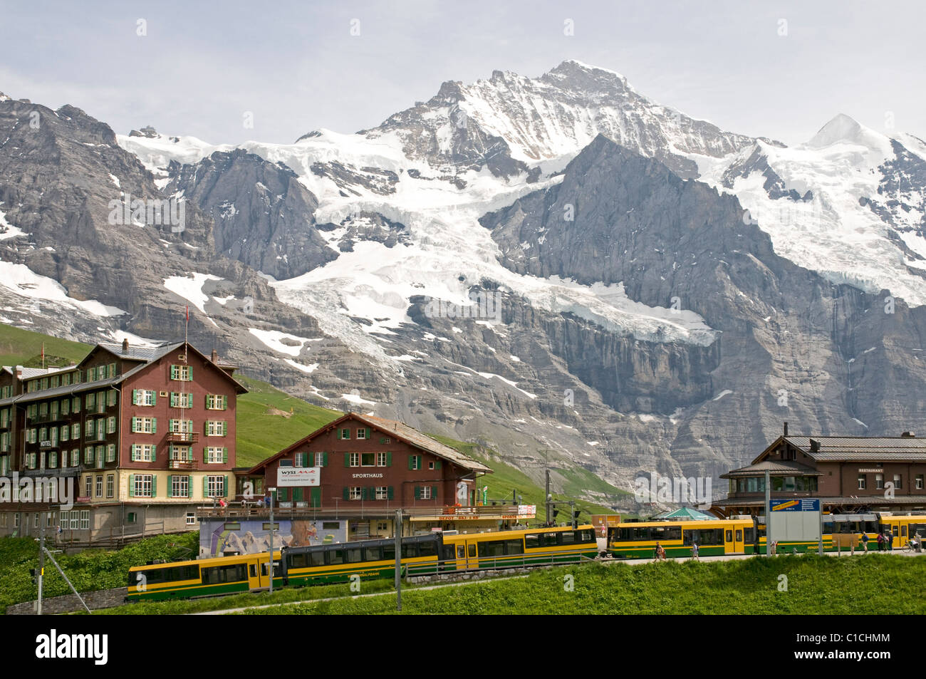 Scene at Kleine Scheidegg in the Swiss Alps, with the Jungfrau and Silberhorn peaks behind Stock Photo
