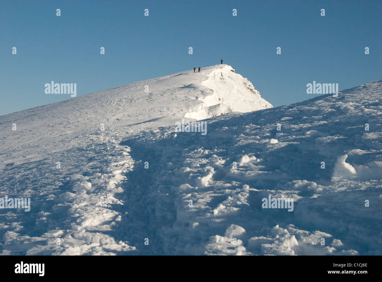 Snowy footpath on the summit ridge of Blencathra in winter n the English Lake District Stock Photo