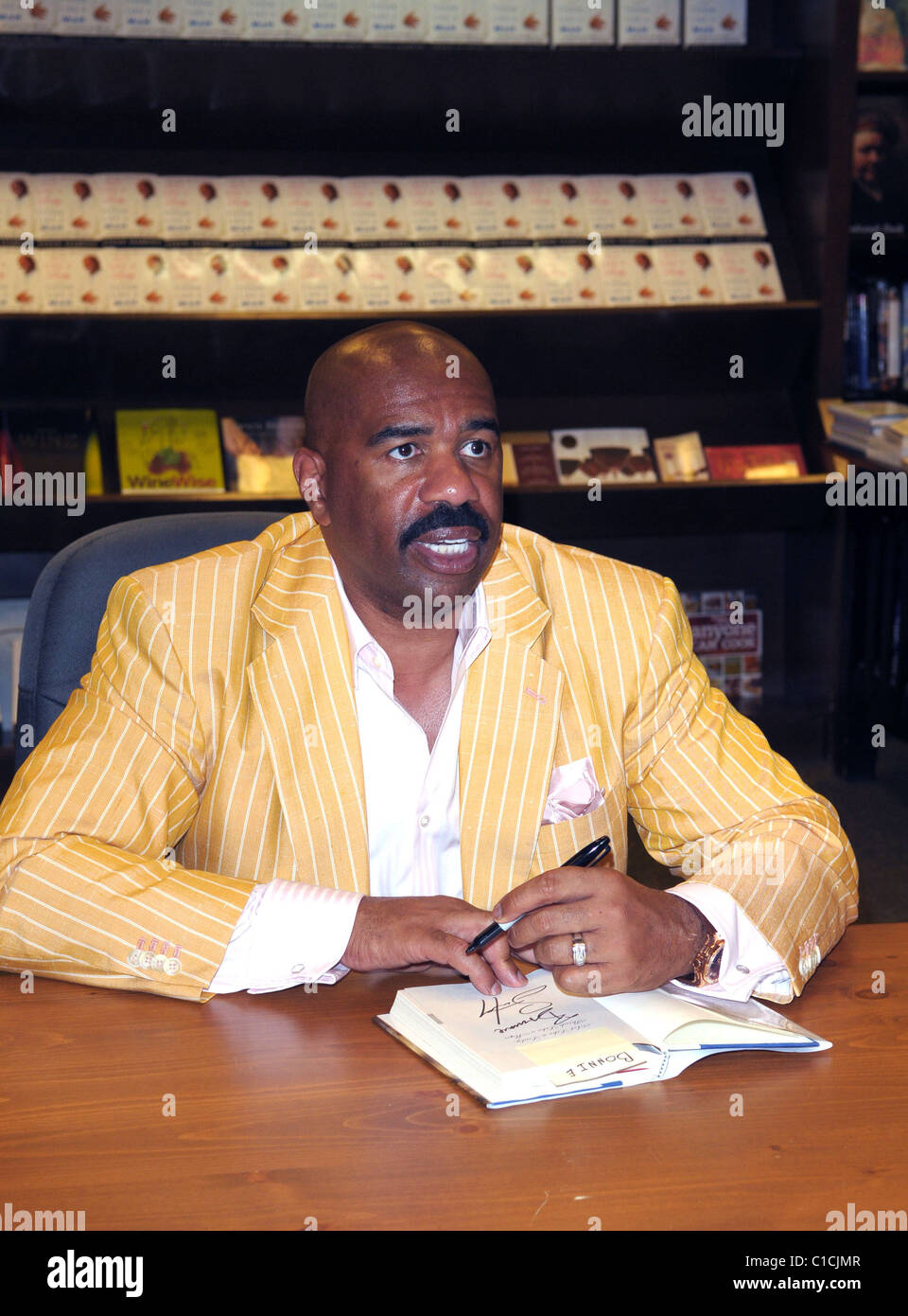 Steve Harvey signs copies of his book 