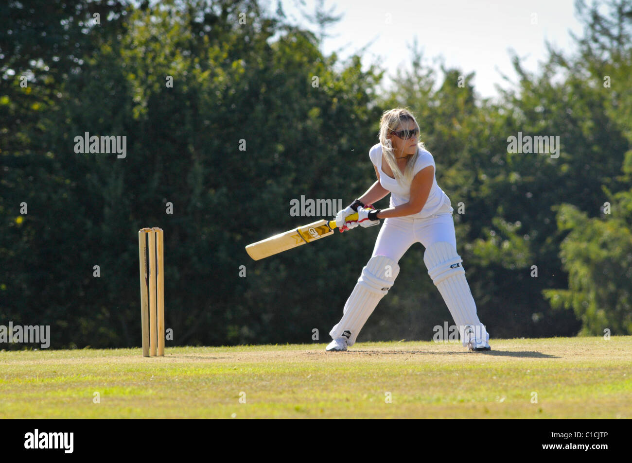 woman in early twenties playing cricket for fun. Stock Photo