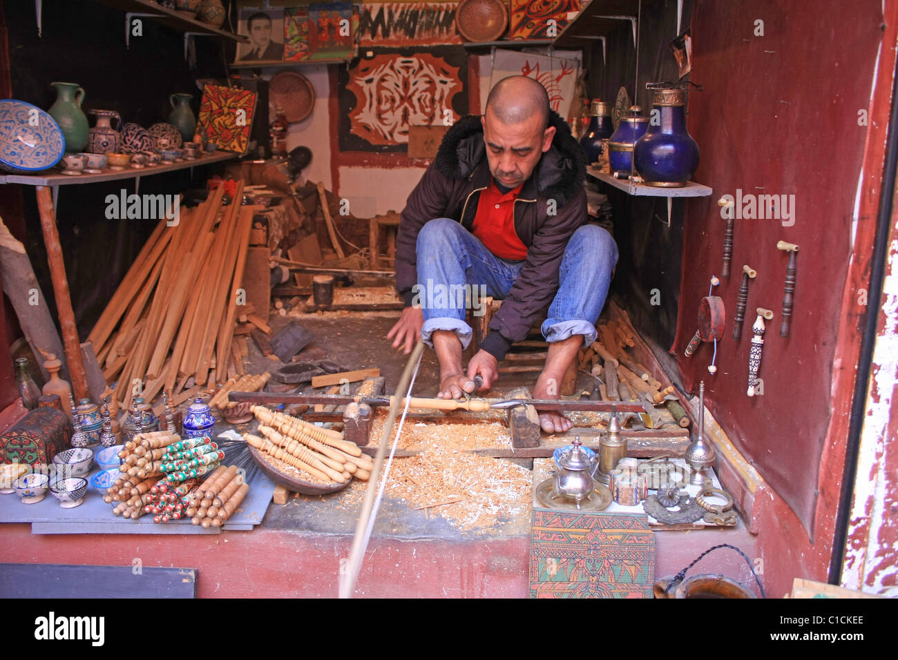 A Moroccan carpenter shapes wood in the souks in Marrakesh Stock Photo