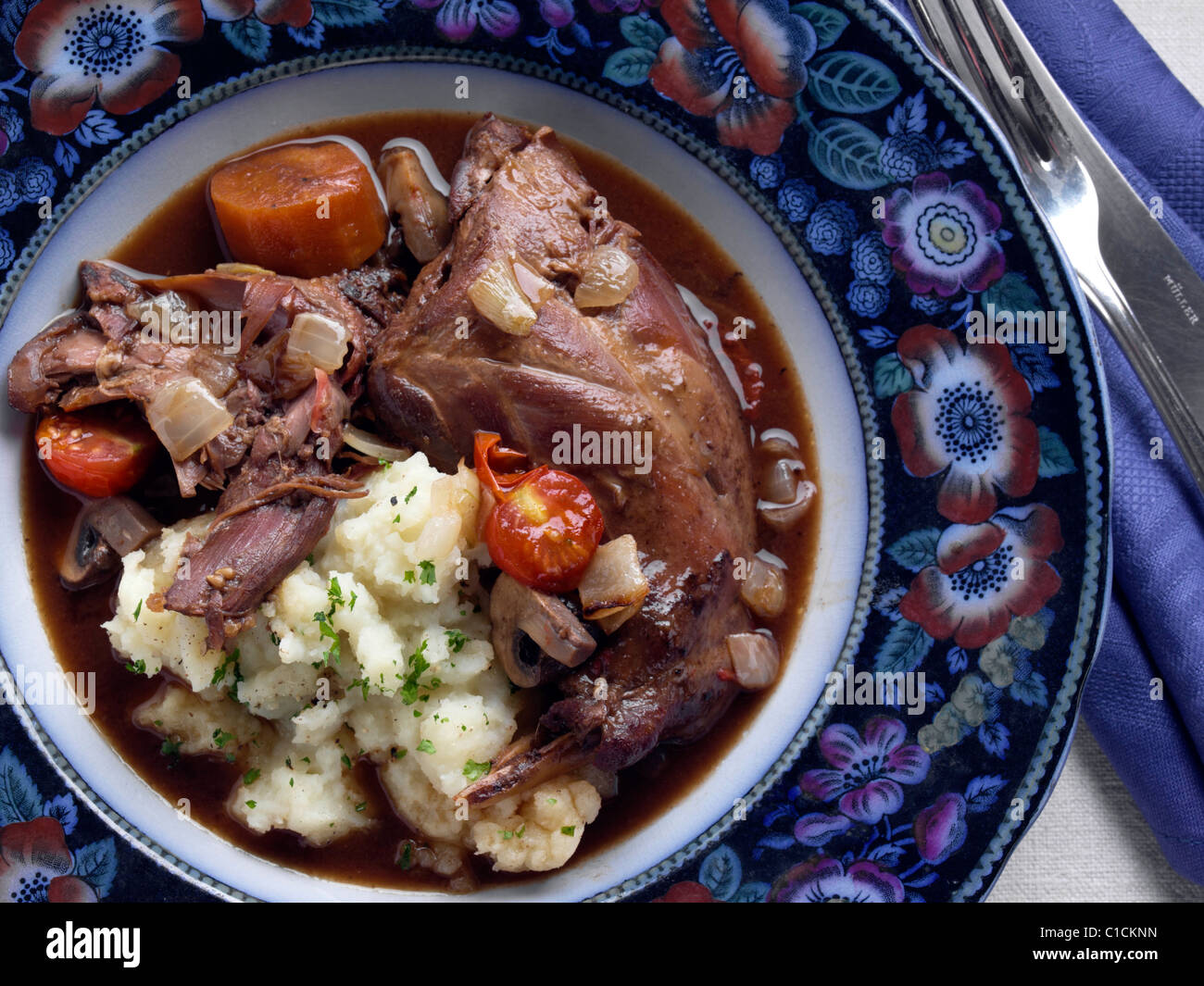 An antique plate of rabbit stew Stock Photo