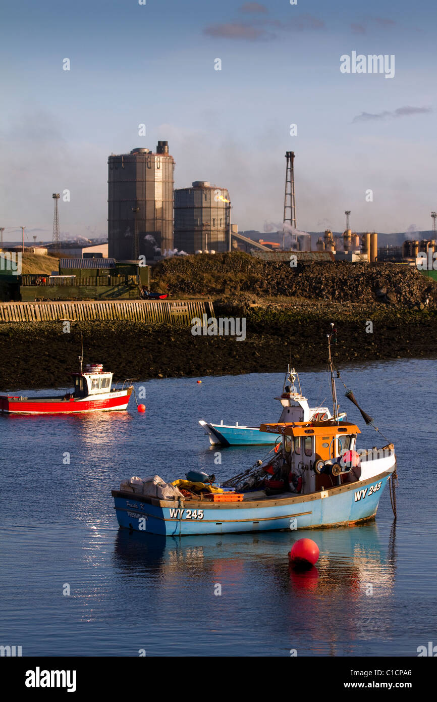 Fishermen's Boats at anchor in Paddy's Hole harbour, mini-harbour Inlet and the British steel Steelworks at South Gare, Redcar, North Yorkshire, UK Stock Photo