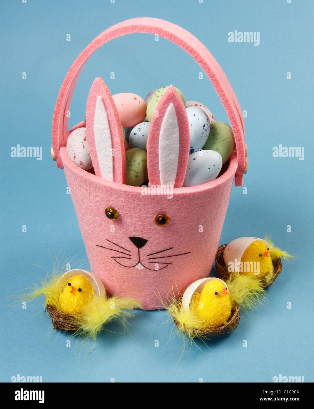 Cute Pink Bunny Basket with Easter Eggs and Chicks on Blue Background
