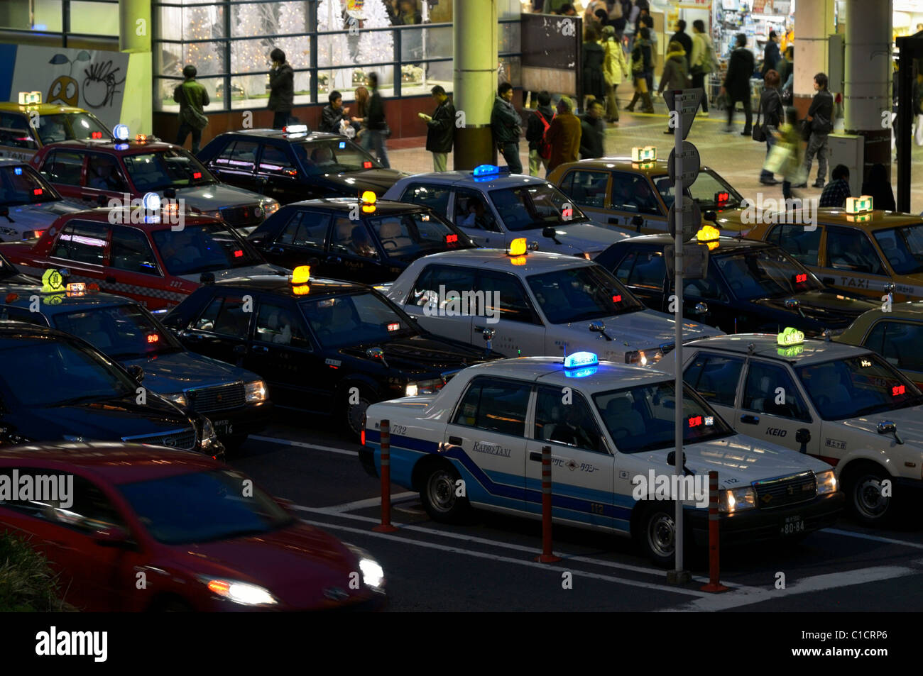 A line up of Japanese taxis waiting for passengers at Yokohama JR station, Kanagawa, Japan JP Stock Photo
