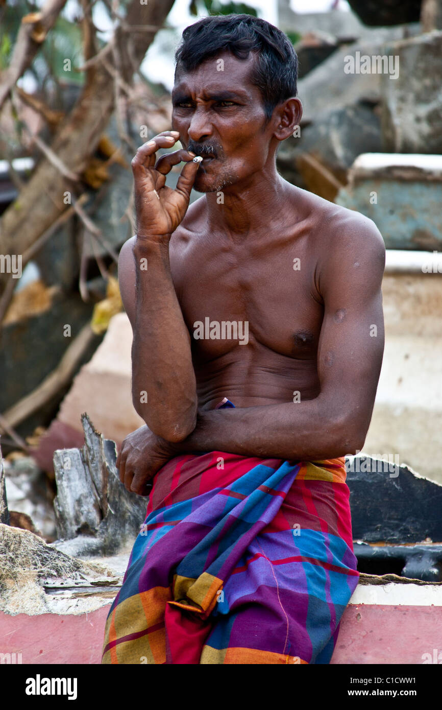 Sri Lankan Fisherman smoking a cigarette Stock Photo