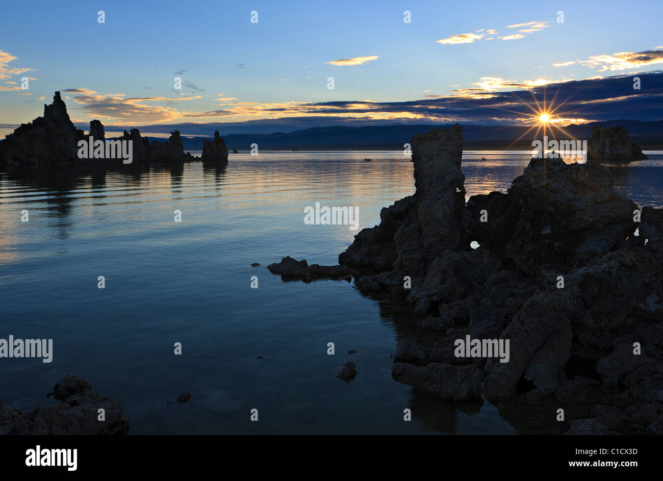 A rising sun (sun star) over Mono Lake, California, USA. Stock Photo