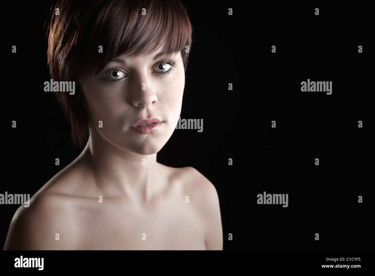 Beautiful Teenage Girl against Black Background Stock Photo