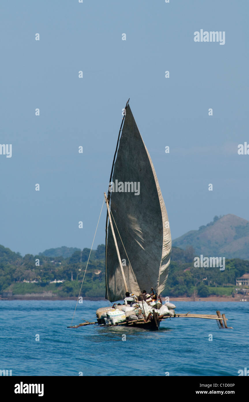 Madagascar, Indian Ocean, off the coast of the island of Nosy Be. Typical local Malagasy sailing outrigger. Stock Photo