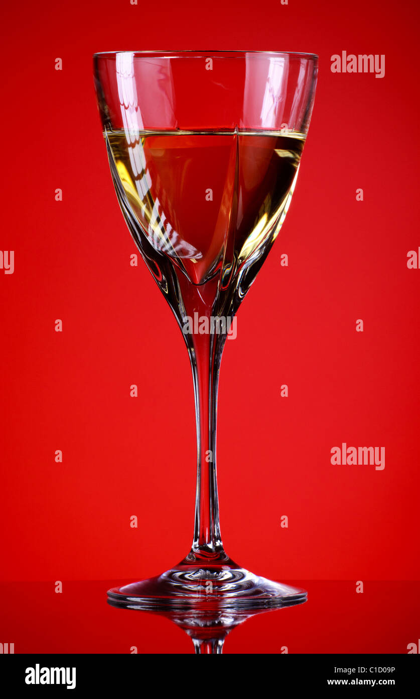 glass of white wine, red background Stock Photo