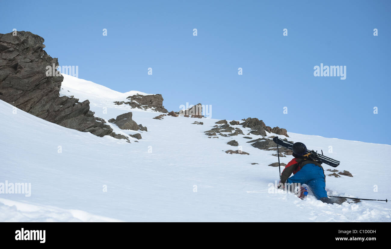 A free skier climbing up a snowy mountain side near La Grave, France Stock Photo