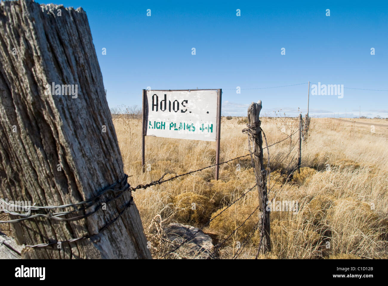 An old 4-H sign is weather-worn from the wind and extreme temperatures of northeastern New Mexico. Stock Photo