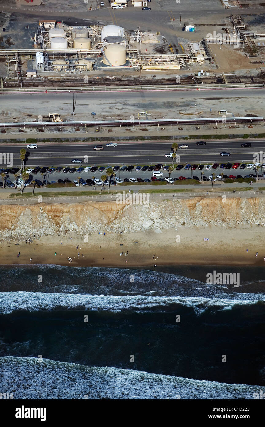 aerial view above Huntington Dog Beach adjacent to oil well production Huntington Beach California Stock Photo