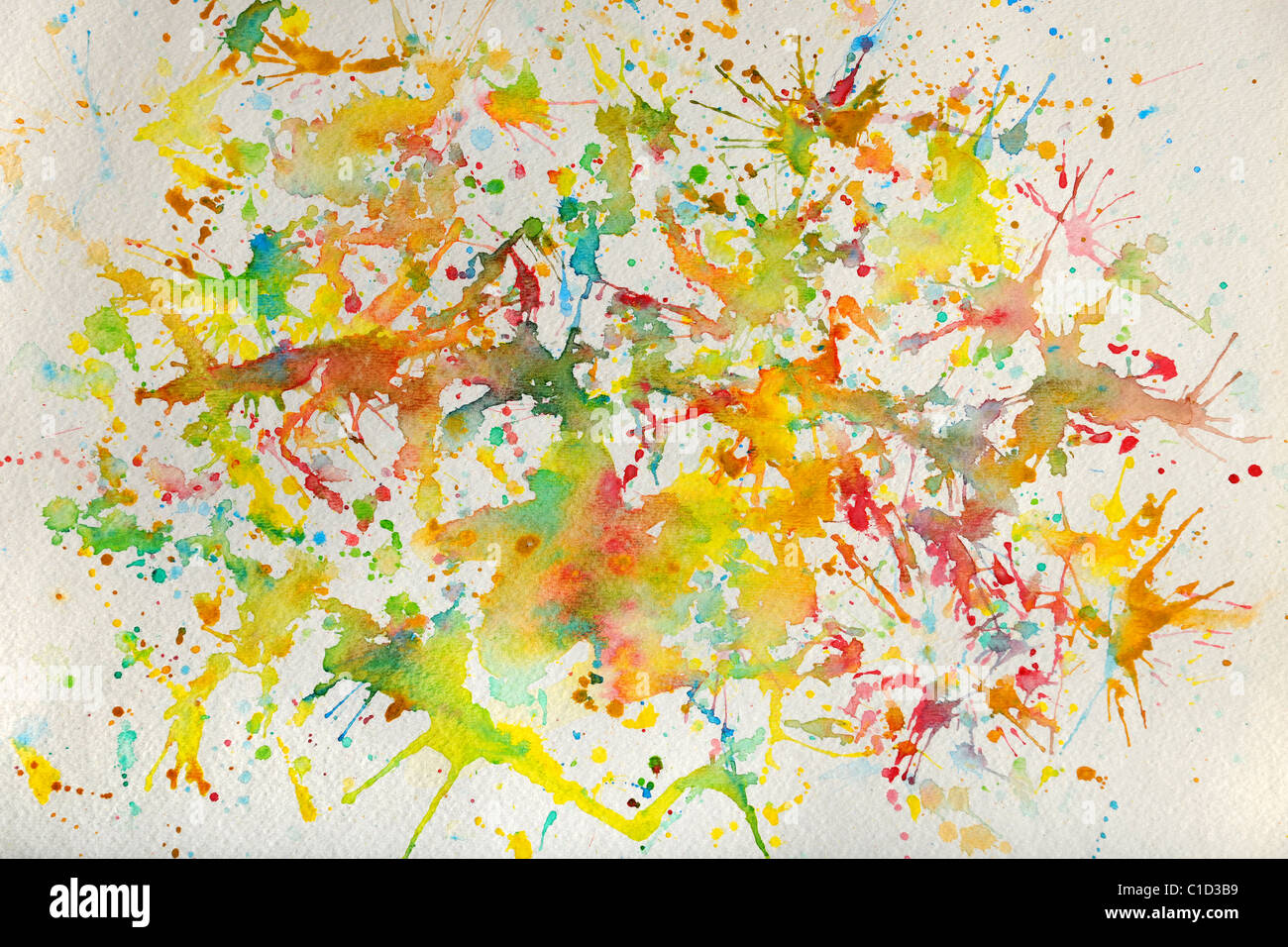 Watercolor splashes of different colors over textured paper Stock Photo