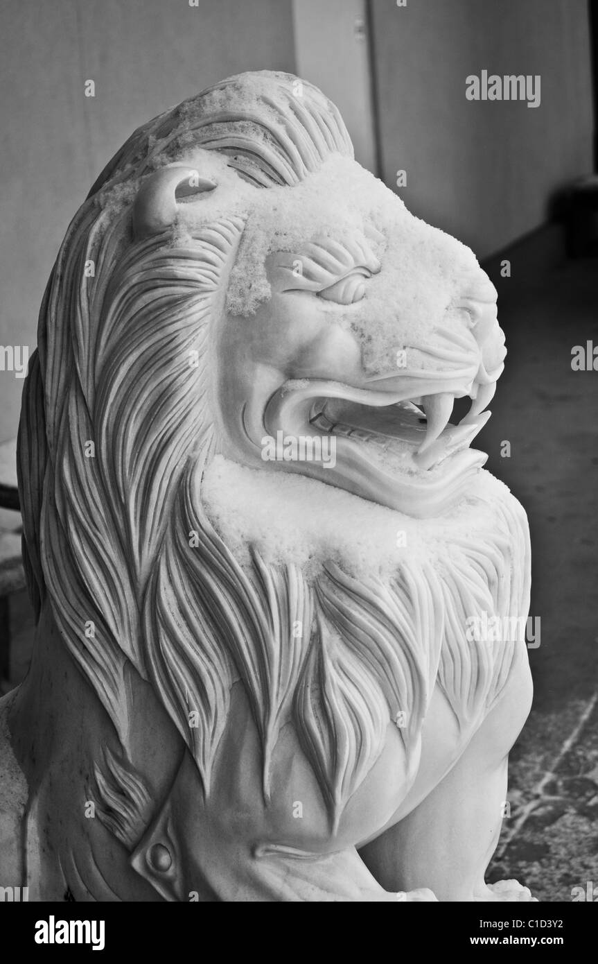 A snow-covered lion statue in front of a Chinese Restaurant in Atlanta, GA. Taken during the snow storms of 2011. Stock Photo